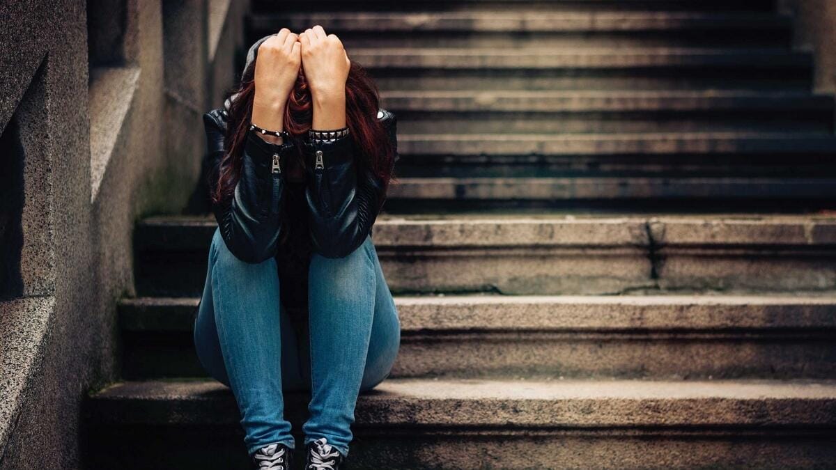 a girl sitting on the steps PTSD