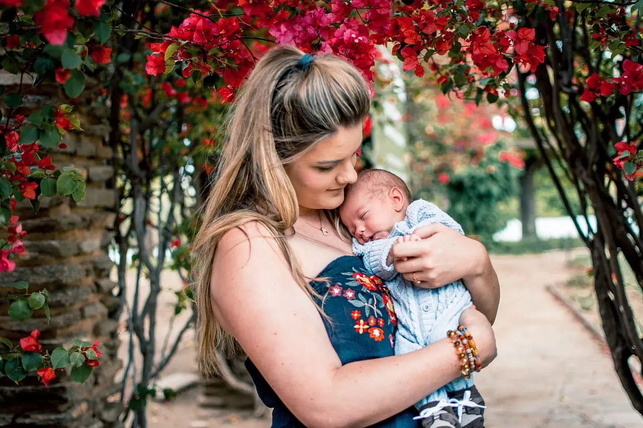 A mother holding her baby close, showing the bond that counseling for new mothers helps to protect