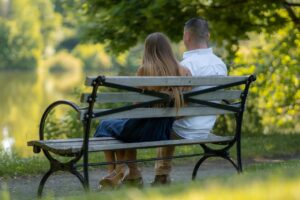 Couple on a bench, Traditional roles in relationships, gender roles, men as providers, women as nurturers, relationship dynamics, emotional connection, intimacy, divorce rates, relationship polarity, James Bauer, John Gray.